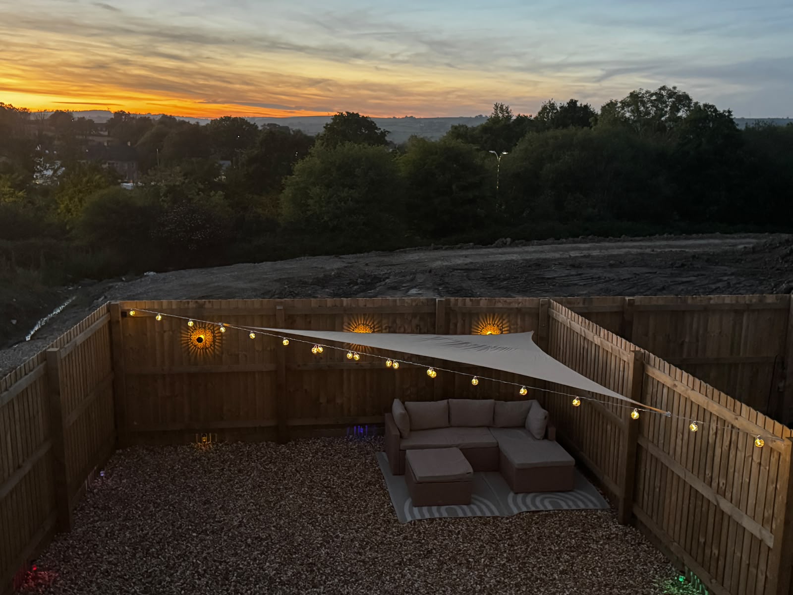 SPAN-KIT garden installation at sunset — string lights spanning the garden with shade sail